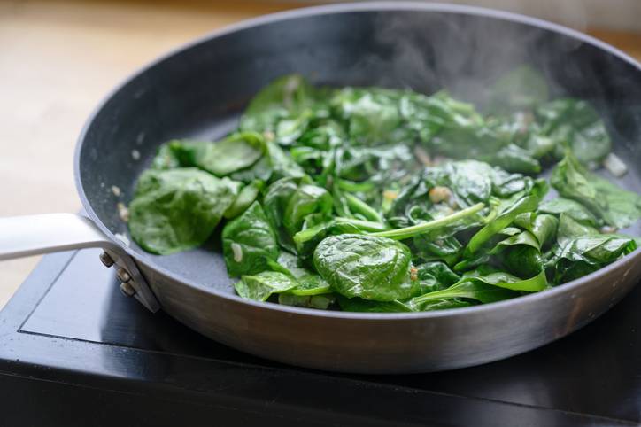 Cooked spinach in a pan on the hob