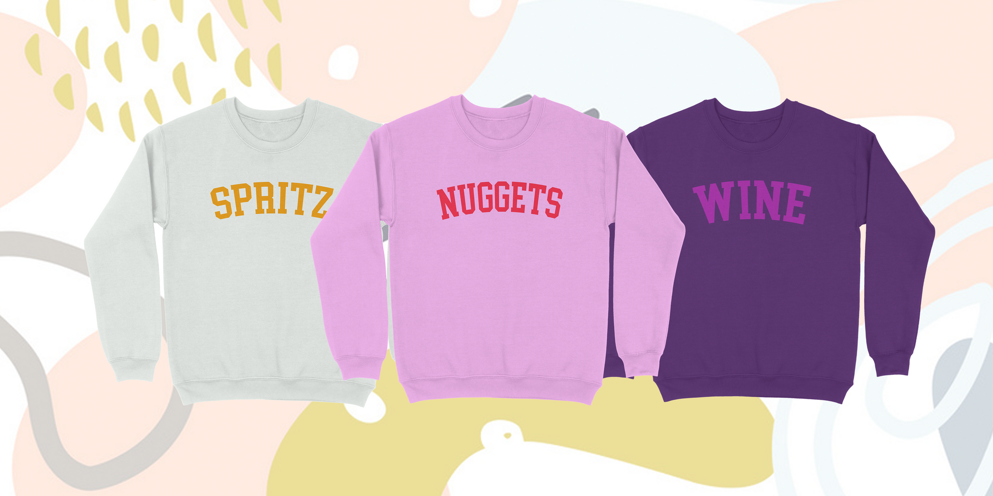 three collegiate style sweaters with the words "wine" "spritz" or "nuggets" on the front