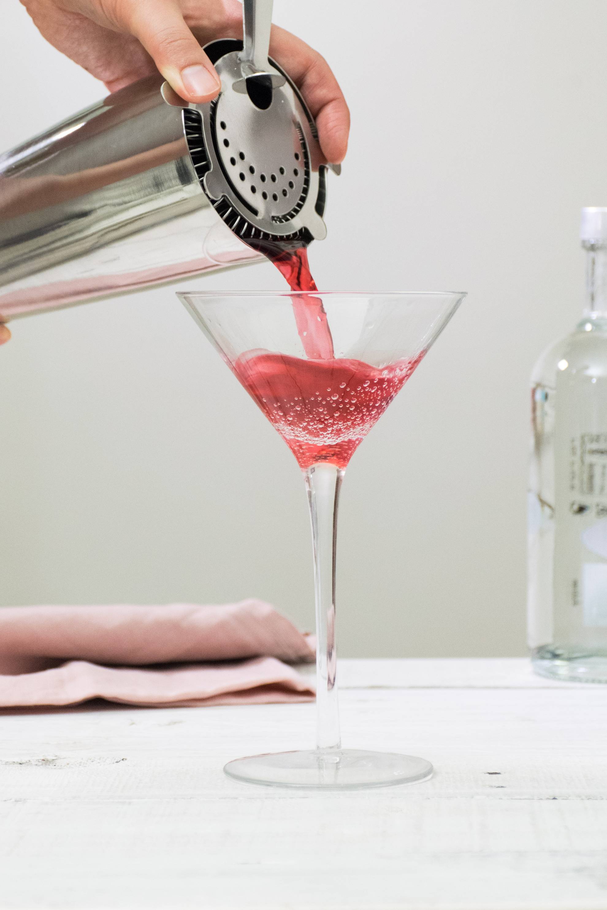 pouring a cosmpolitan cocktail
