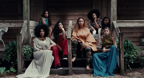 Beyonce sits with no make up surrounded by other women