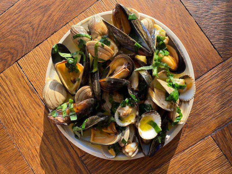 A bowl of grilled mussells and garlic butter