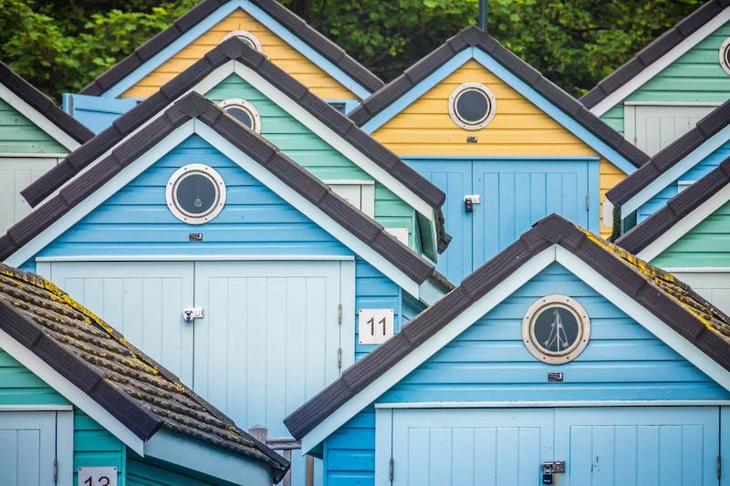 Pastel blue, green and yellow beach huts in Bournemouth
