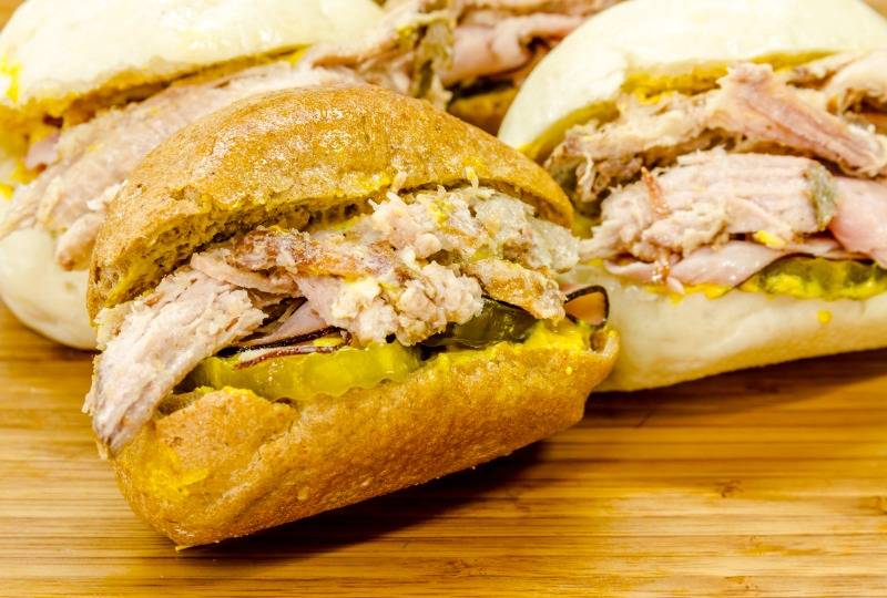 Cuban medianoche sandwich made with ham, Swiss cheese and pickle