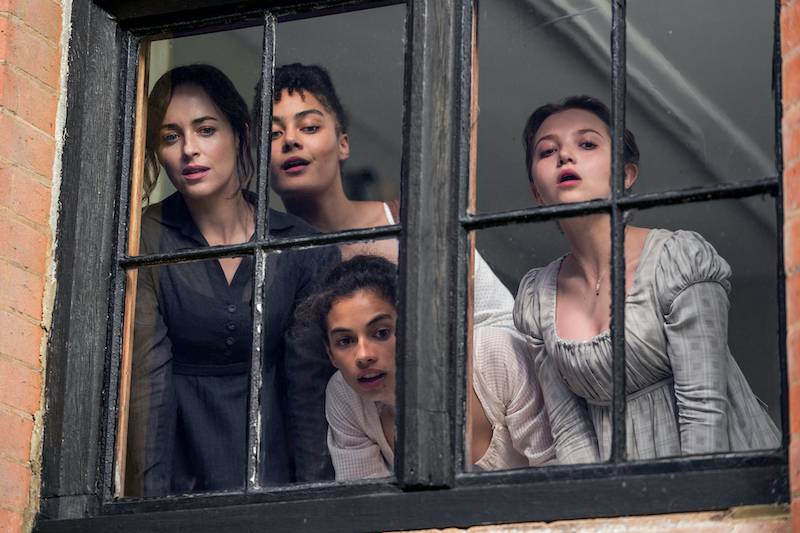 Dakota Johnson plays Anne Elliott spying out of a window with her sisters in Netlix's Persuasion