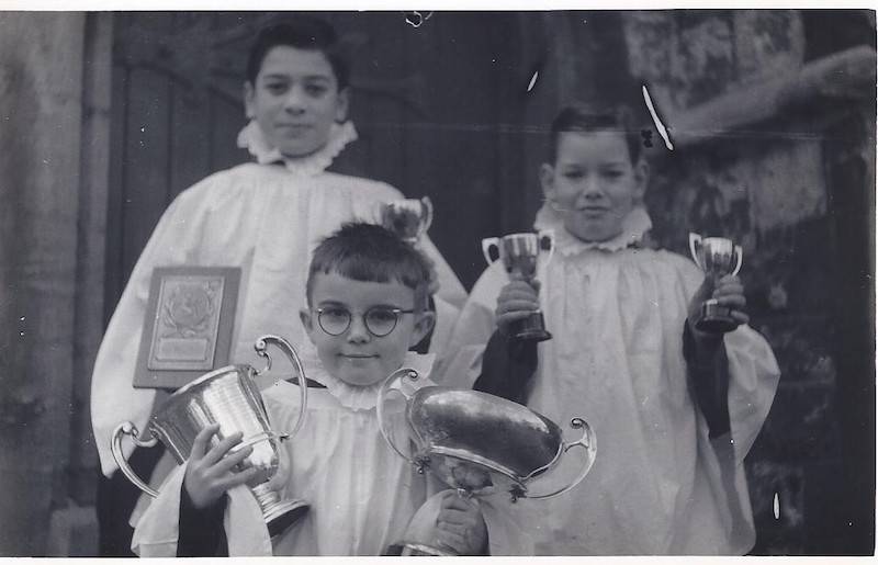 Andy Hamilton posing with awards won by his choir group in 1961