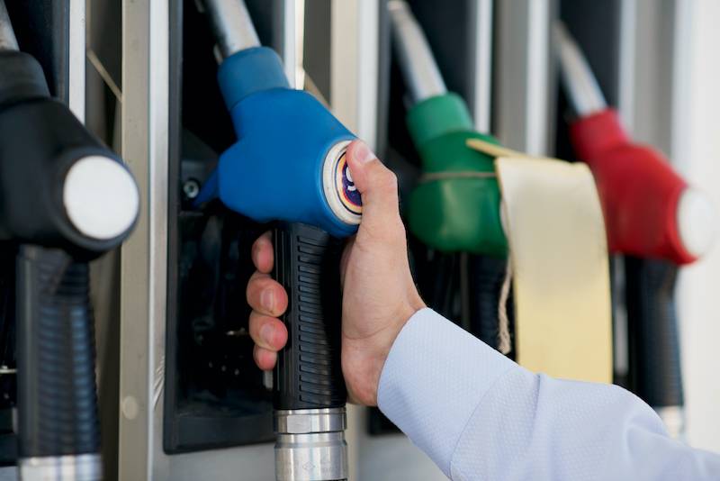Person choosing fuel at petrol station
