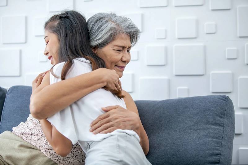 Older woman hugging younger woman - widow guide to first year