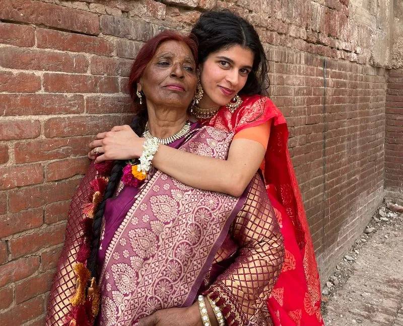 Mother and daughter both wearing saris