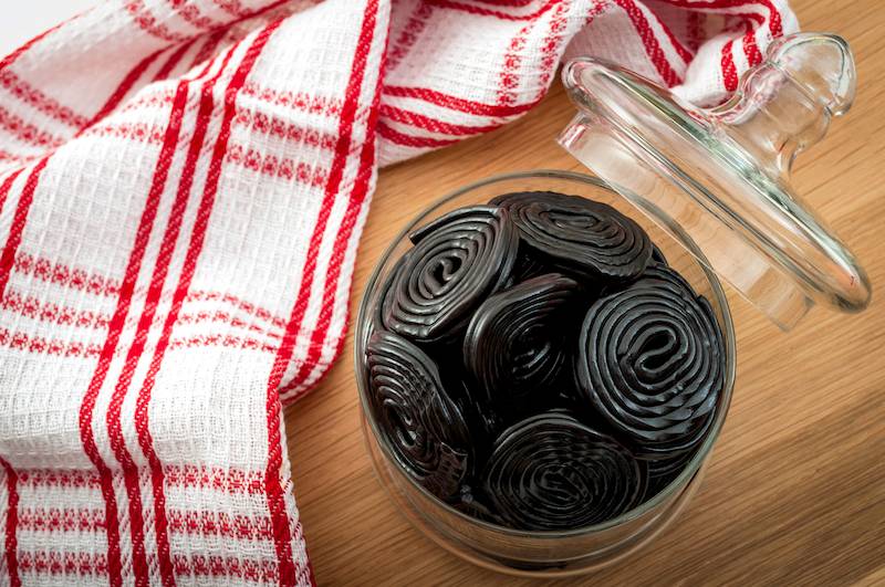 Modern liquorice sweet in a jar next to a red and white cloth