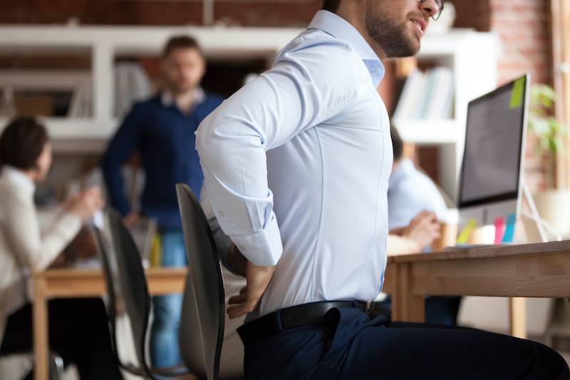 Man with bad posture sitting at desk