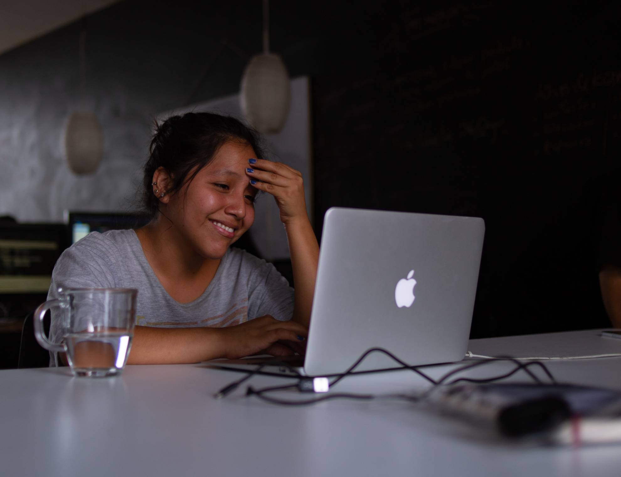 girl smiling at laptop