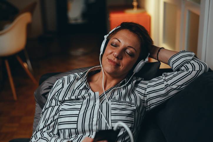 woman reclining with headphones