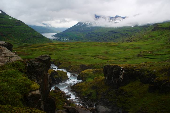 a stream and hills in Seyðisfjörður iceland