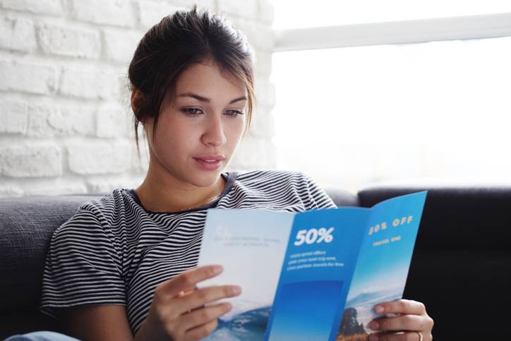 a woman reading a clear leaflet