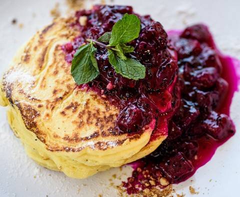 Delicious cottage cheese pancakes with berry fruit compote