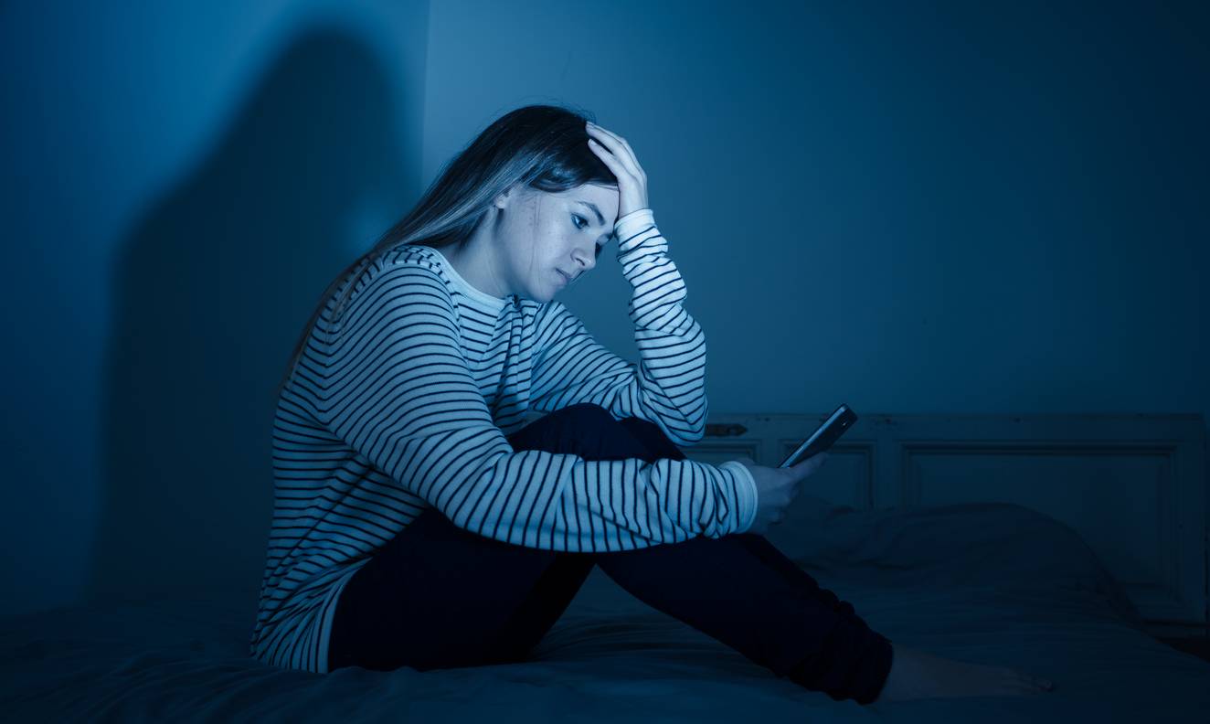 Woman stressed while looking at phone