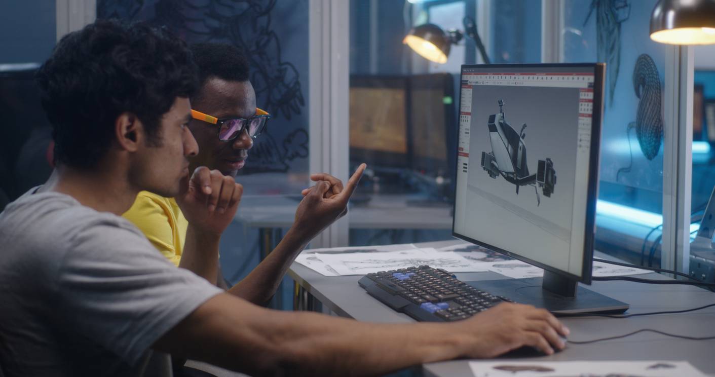Two men using a desktop computer