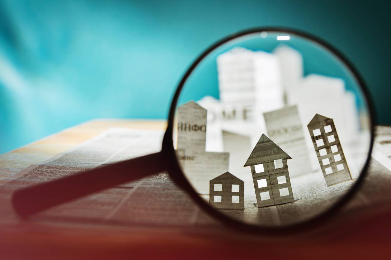 Paper houses under a magnifying glass